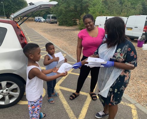 get ready pic 1 Abena handing out educational worksheets during COVID
